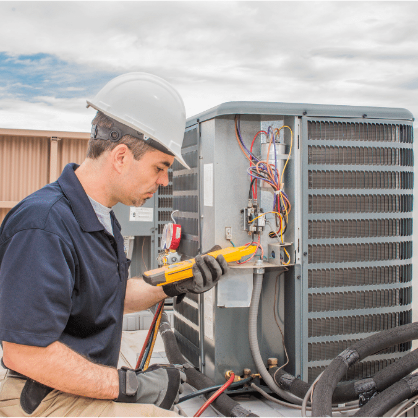 Paris Heating & Cooling HVAC technician servicing a system