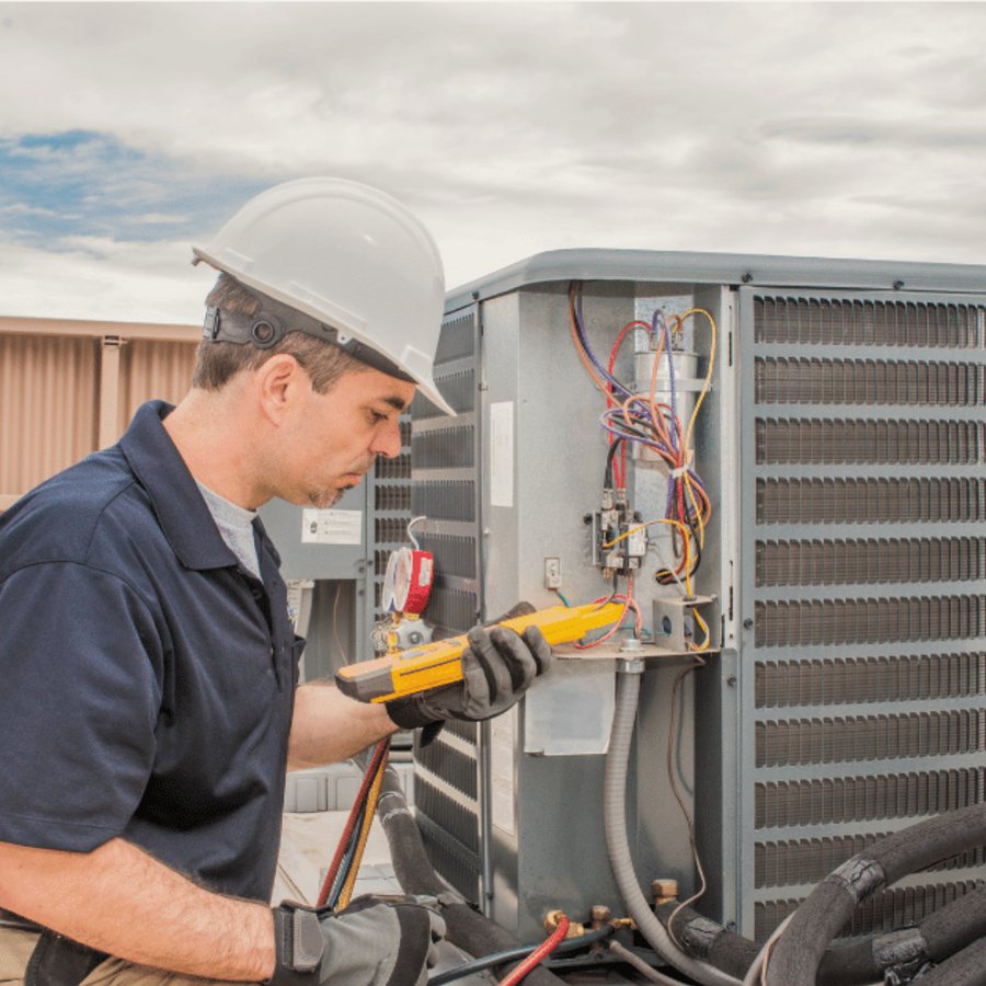 Paris Heating & Cooling HVAC technician servicing a system